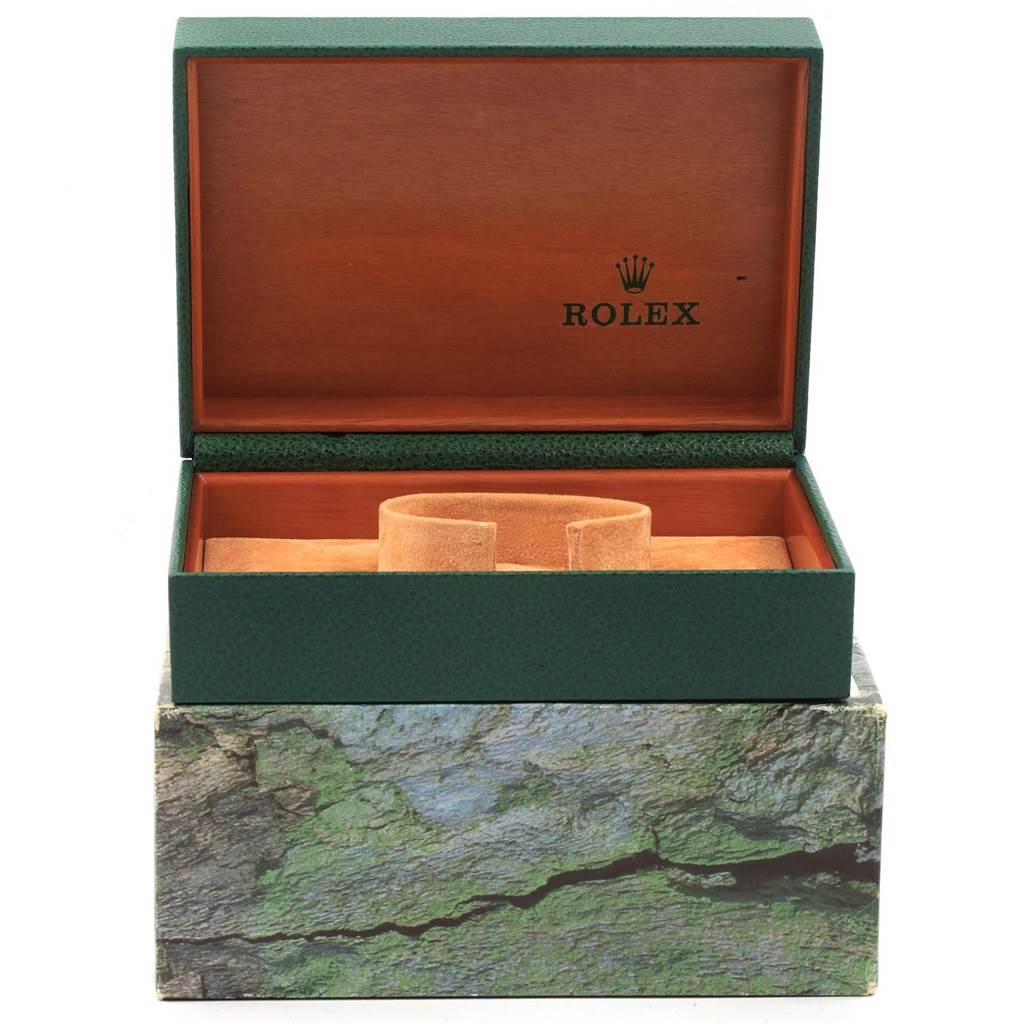 The image shows an open green Rolex case for a Datejust model, revealing the interior cushion and wooden interior.