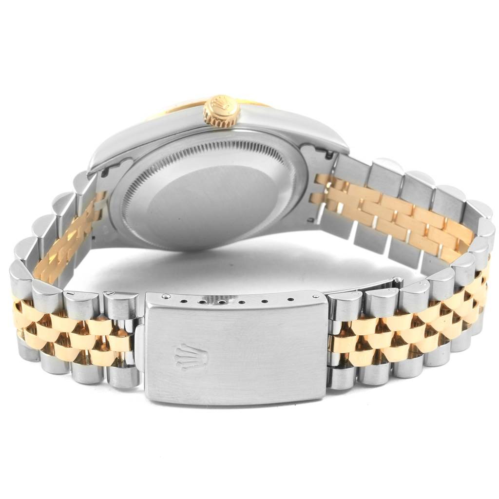 The Rolex Datejust 16233 Men's Steel and Gold (two tone) Beige Dial 16233 Men's Steel and Gold (two tone) Beige Dial watch is shown from the back, highlighting its case back, crown, and two-tone bracelet with a clasp.