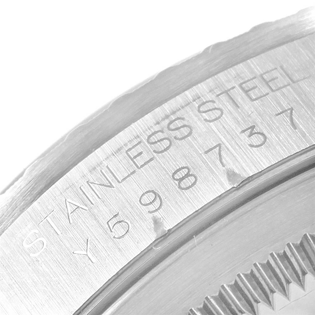 This close-up image shows the stainless steel case back of the Rolex Datejust 16220 Men
s Stainless Steel Black Dial 16220 Men
s Stainless Steel Black Dial model, featuring the engraved serial number.