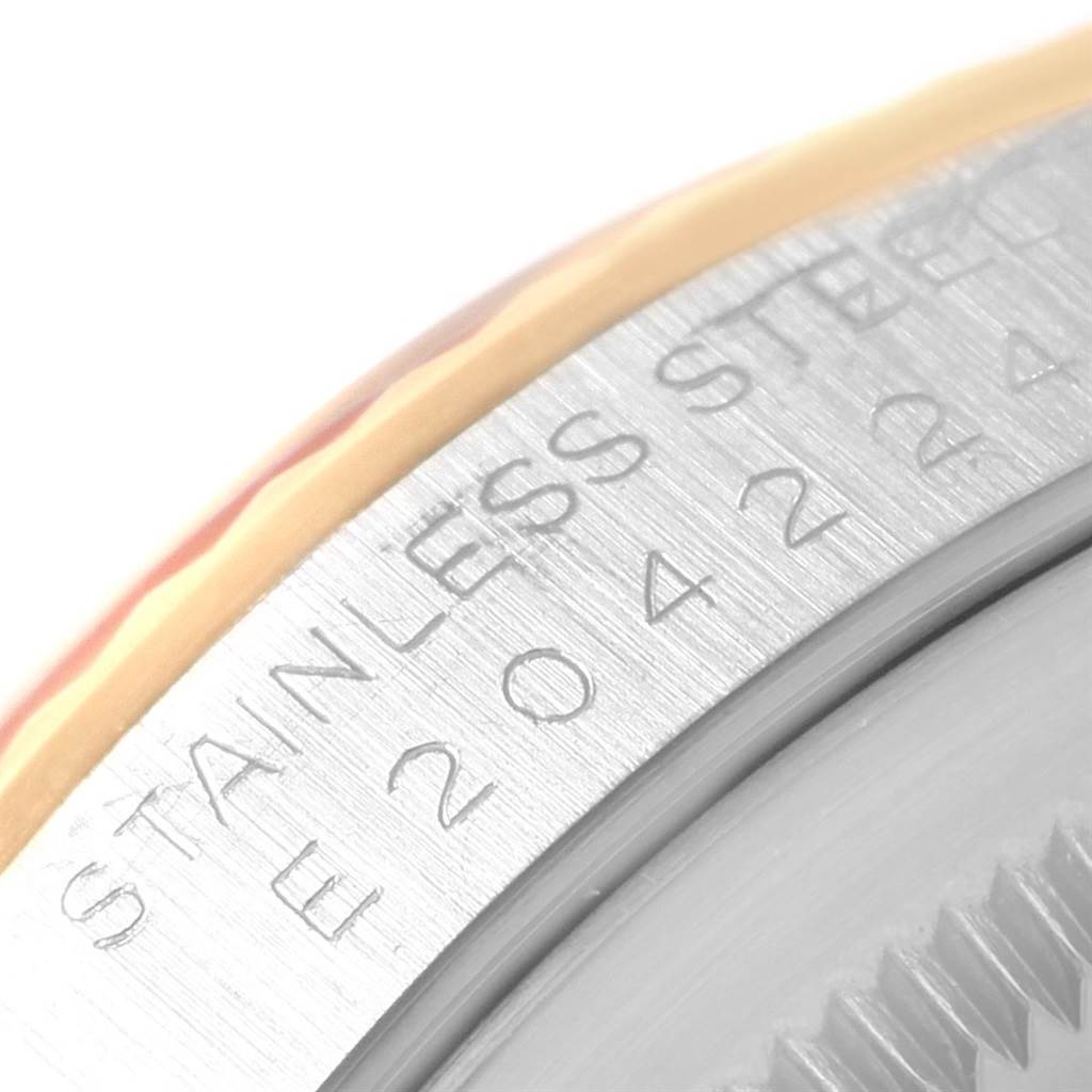 This close-up of the Rolex Datejust 16233 Men
s Steel and Gold (two tone) Beige Dial 16233 Men
s Steel and Gold (two tone) Beige Dial watch shows part of the case back and the "STAINLESS STEEL" engraving.