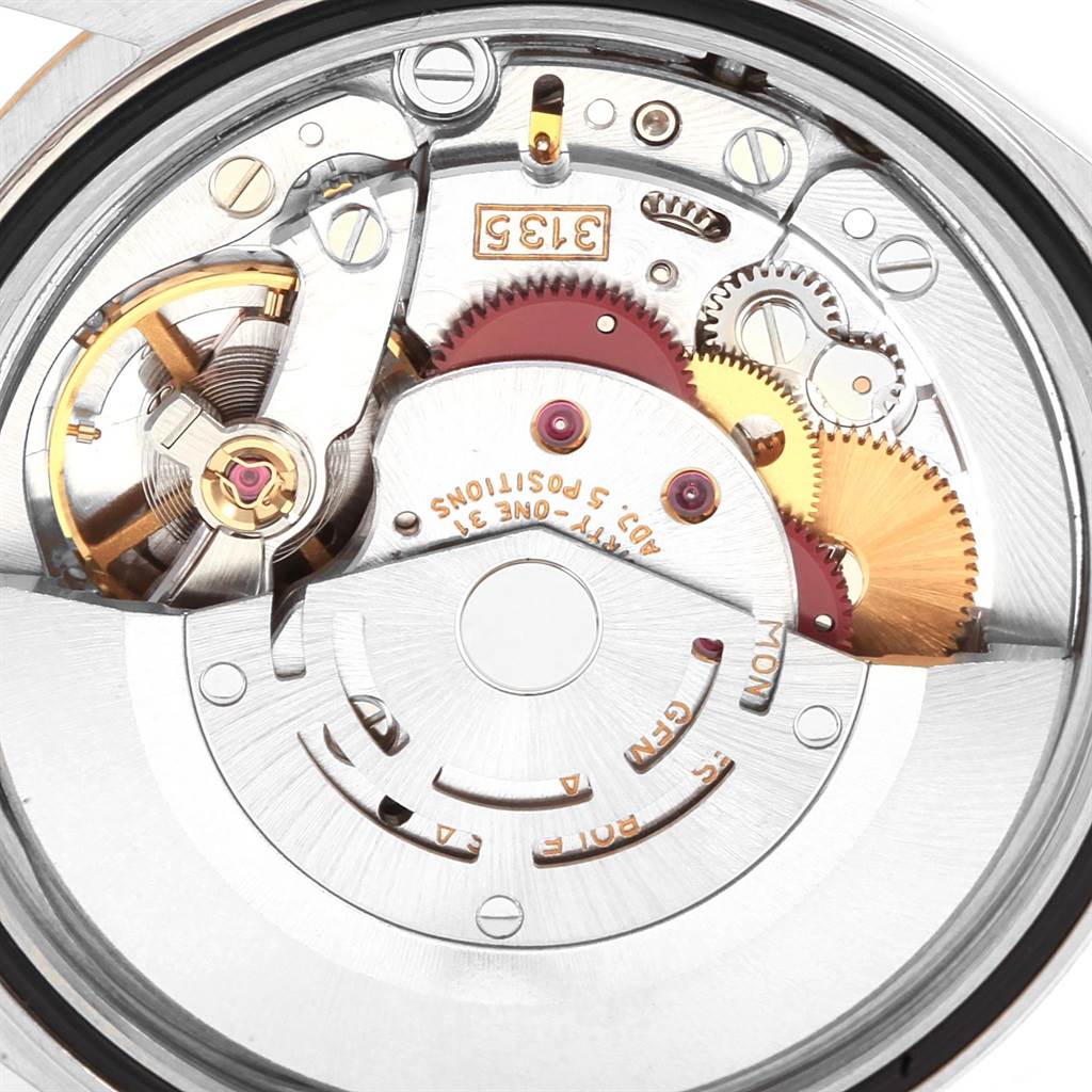 This close-up image shows the internal mechanical movement of a Rolex Datejust 16233 Men
s Steel and Gold (two tone) Beige Dial 16233 Men
s Steel and Gold (two tone) Beige Dial watch.