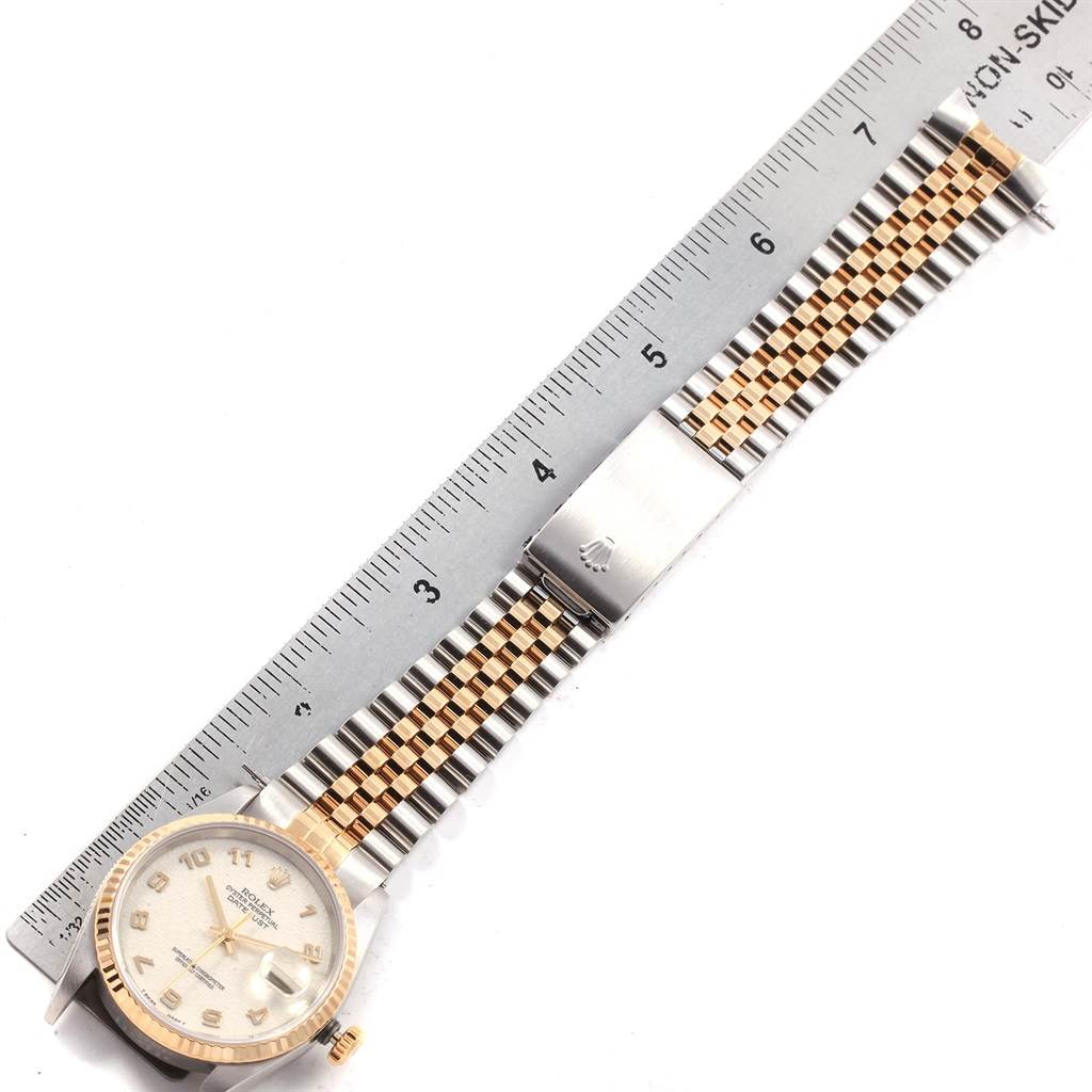 The image shows a top-down view of a Rolex Datejust 16233 Men
s Steel and Gold (two tone) Beige Dial 16233 Men
s Steel and Gold (two tone) Beige Dial watch, highlighting the face, strap, and clasp with a ruler for scale.