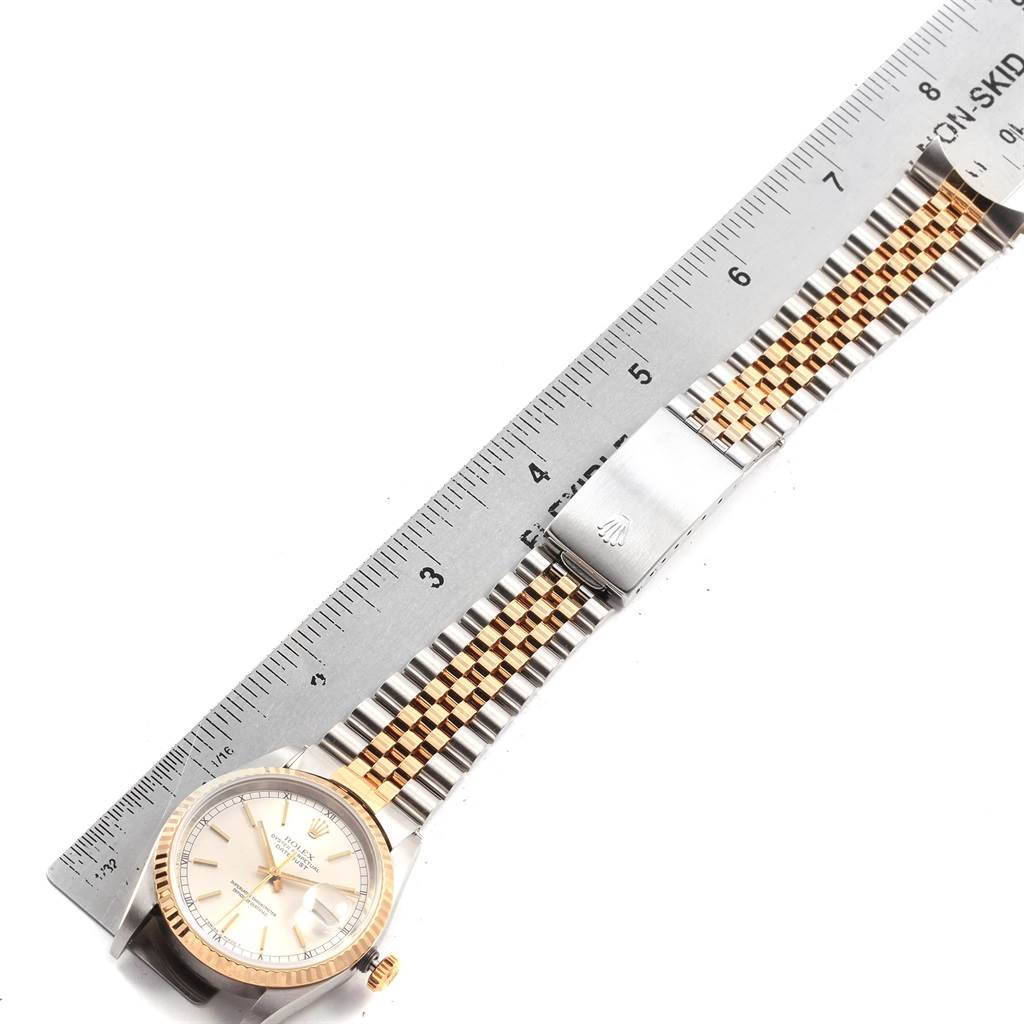 The photo shows a Rolex Datejust 16233 Men's Steel and Gold (two tone) Silver Dial 16233 Men's Steel and Gold (two tone) Silver Dial watch lying flat with a metal ruler measuring its two-tone bracelet.