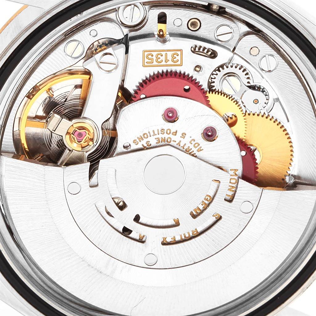 The image shows a close-up of the movement's intricate inner mechanics of the Rolex Datejust 16233 Men's Steel and Gold (two tone) Silver Dial 16233 Men's Steel and Gold (two tone) Silver Dial watch.