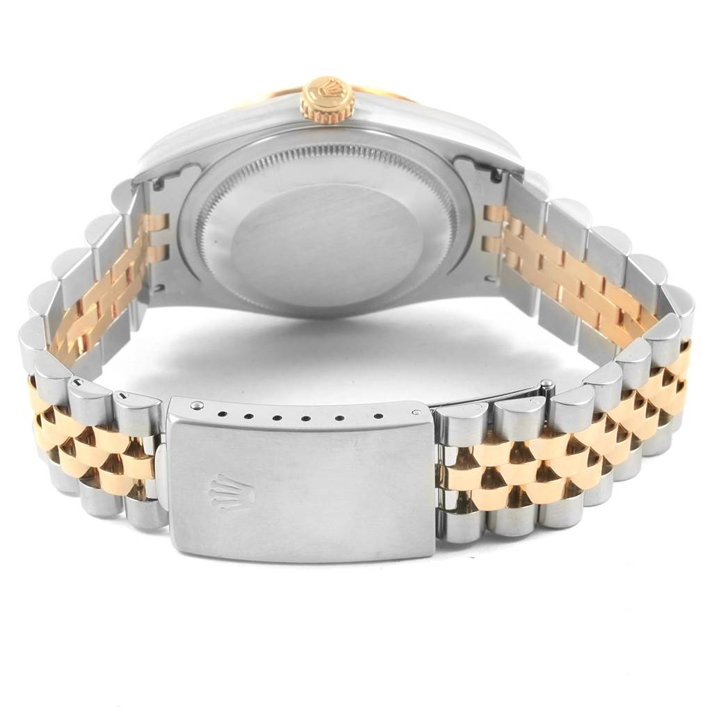 This image shows the back case and clasp of a Rolex Datejust 16233 Men's Steel and Gold (two tone) Silver Dial 16233 Men's Steel and Gold (two tone) Silver Dial watch with a two-tone metal bracelet.