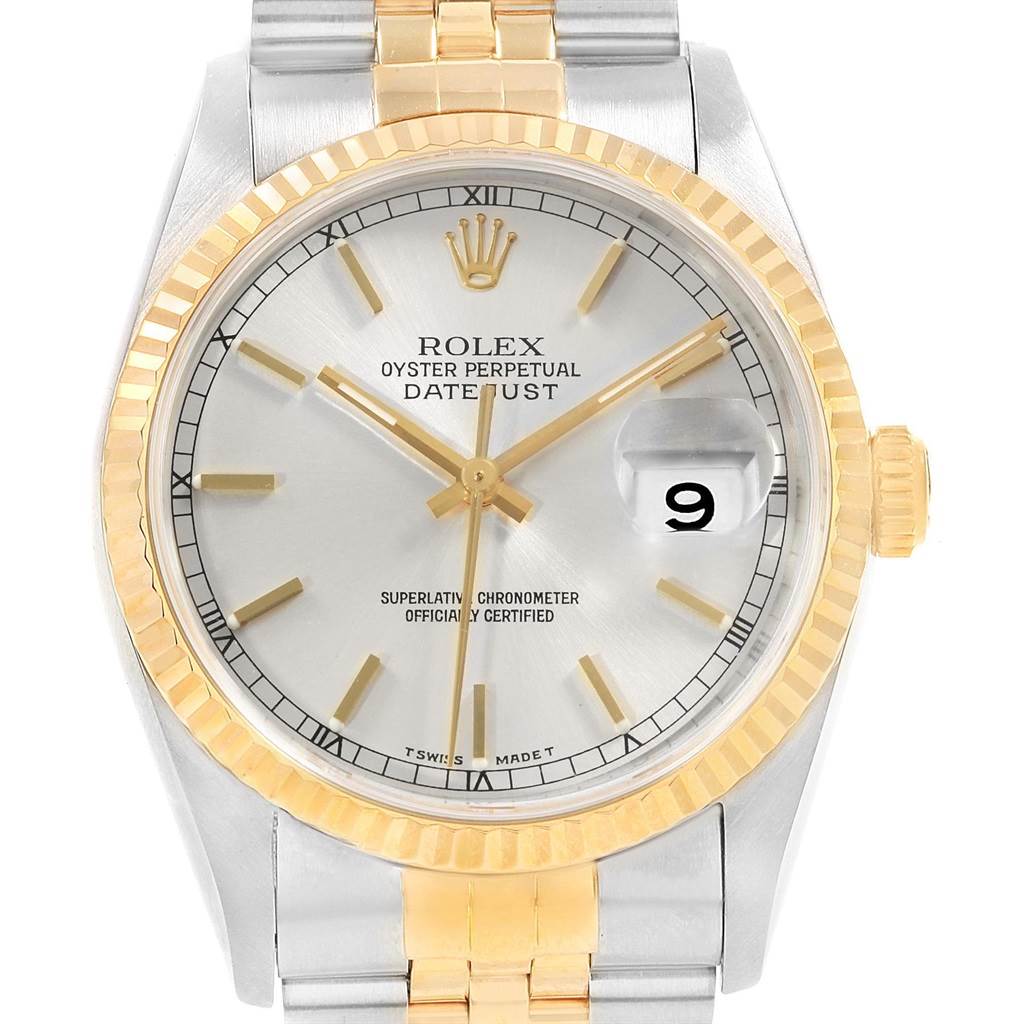 This is a close-up view of a Rolex Datejust 16233 Men's Steel and Gold (two tone) Silver Dial 16233 Men's Steel and Gold (two tone) Silver Dial watch showing the dial, crown, bezel, and part of the bracelet.