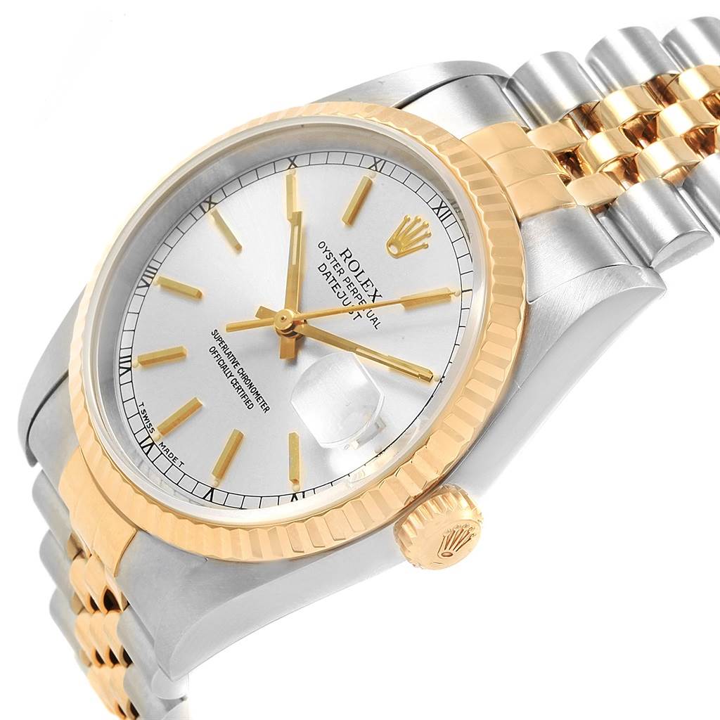 This image shows a Rolex Datejust 16233 Men's Steel and Gold (two tone) Silver Dial 16233 Men's Steel and Gold (two tone) Silver Dial watch at an angled view, highlighting its face, crown, and part of the bracelet.