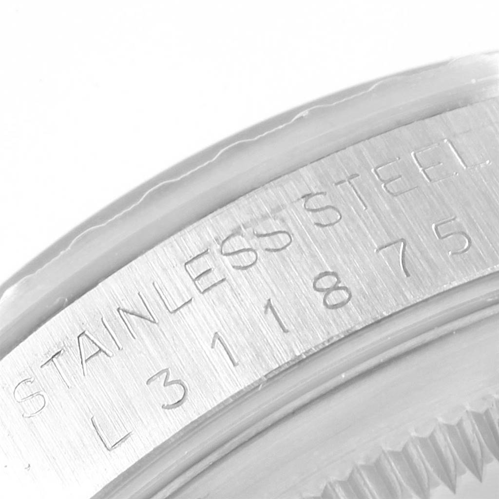 The image shows a close-up of the stainless steel case back of a Rolex Datejust 16220 Men's Stainless Steel Grey Dial 16220 Men's Stainless Steel Grey Dial model, highlighting the engraved serial numbers.