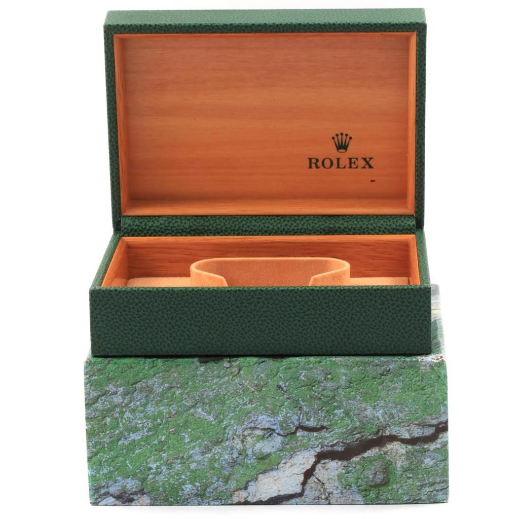 The image shows an open Rolex Datejust 16220 Men
s Stainless Steel Black Dial 16220 Men
s Stainless Steel Black Dial watch box with green exterior and wood interior, but the watch is not visible.