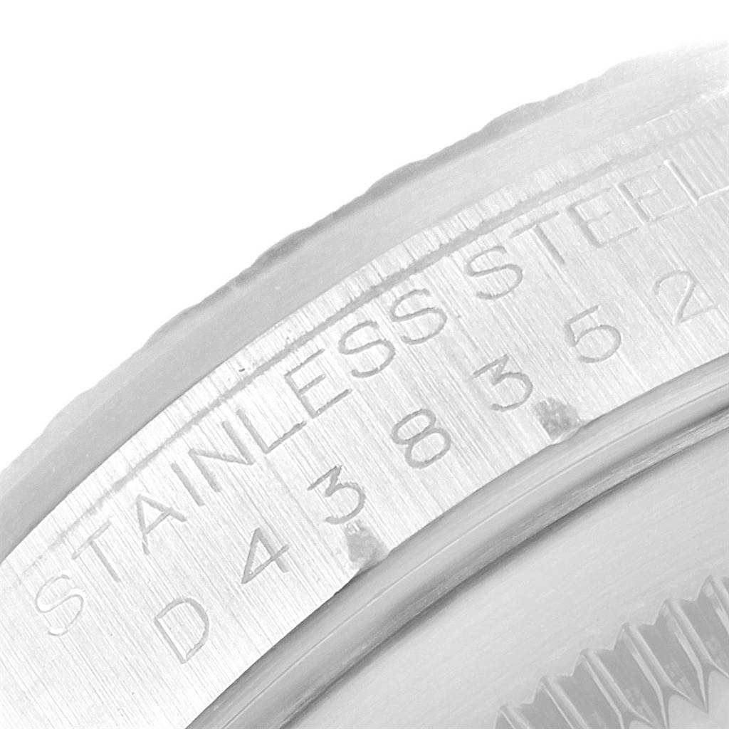 The image shows a close-up of the side of the stainless steel casing of a Rolex Datejust 16220 Men
s Stainless Steel Black Dial 16220 Men
s Stainless Steel Black Dial watch, highlighting the engraved serial number.