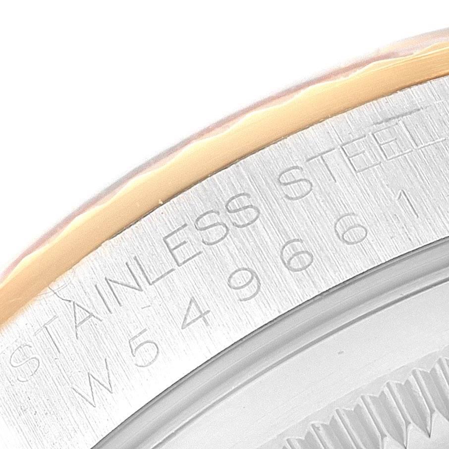 The image shows a close-up of the Rolex Datejust 16233 Men's Steel and Gold (two tone) Champagne Dial 16233 Men's Steel and Gold (two tone) Champagne Dial watch's bezel and part of its engraved serial number.