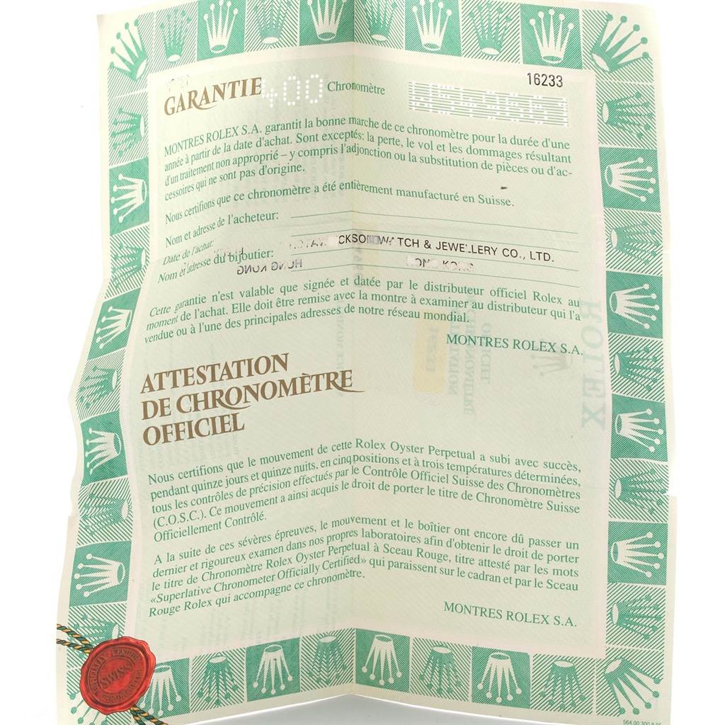 This image shows a close-up of a Rolex Datejust 16233 Men's Steel and Gold (two tone) Champagne Dial 16233 Men's Steel and Gold (two tone) Champagne Dial model's certificate with warranty and official chronometer attestation details.