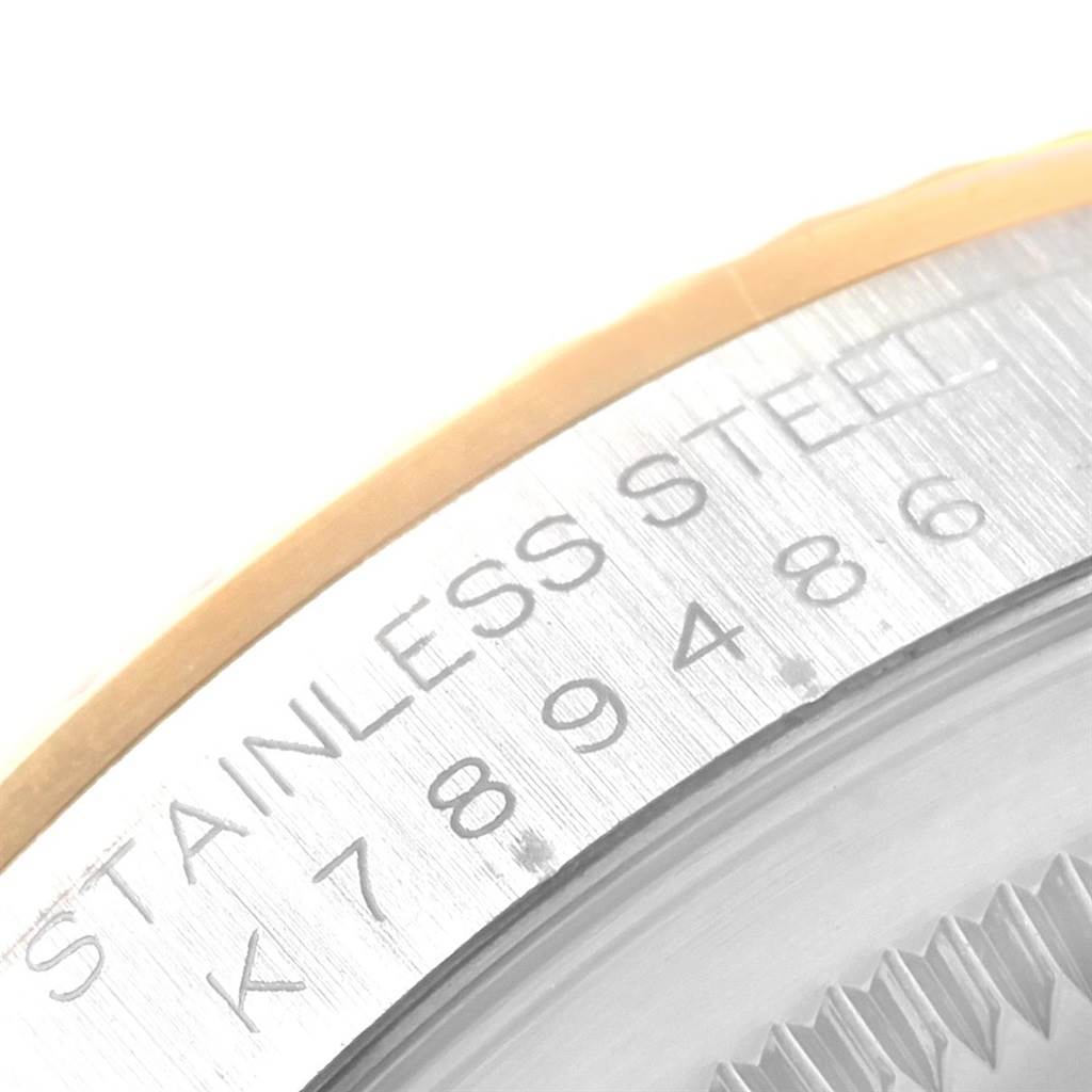 This image shows a close-up view of the engraving on the side of the bezel of a Rolex Datejust 16233 Men's Steel and Gold (two tone) Silver Dial 16233 Men's Steel and Gold (two tone) Silver Dial watch.