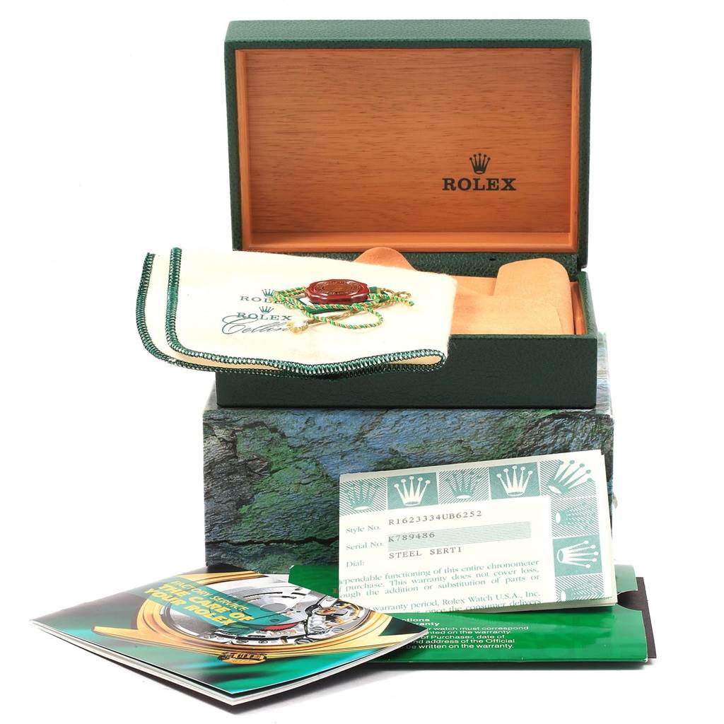 This image shows the packaging, warranty card, cleaning cloth, and other accessories for a Rolex Datejust 16233 Men's Steel and Gold (two tone) Silver Dial 16233 Men's Steel and Gold (two tone) Silver Dial watch.