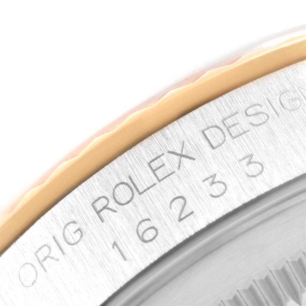 The image shows a close-up of the engraved model and serial number on the bezel of a Rolex Datejust 16233 Men
s Steel and Gold (two tone) Champagne Dial 16233 Men
s Steel and Gold (two tone) Champagne Dial watch.