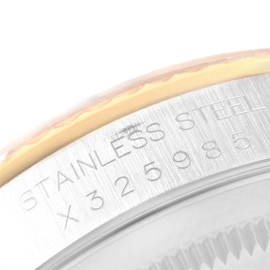 The image shows a close-up of the stainless steel bezel of a Rolex Datejust 16233 Men
s Steel and Gold (two tone) Champagne Dial 16233 Men
s Steel and Gold (two tone) Champagne Dial watch, displaying its serial number.