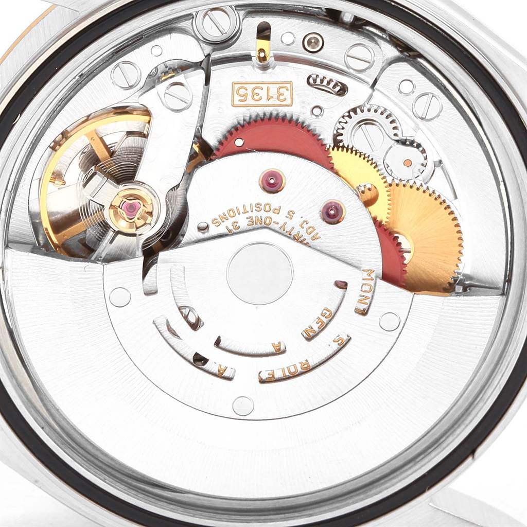 The image shows the Rolex Datejust 16233 Men
s Steel and Gold (two tone) Champagne Dial 16233 Men
s Steel and Gold (two tone) Champagne Dial watch movement, capturing intricate gears and rotor components from a close-up angle.