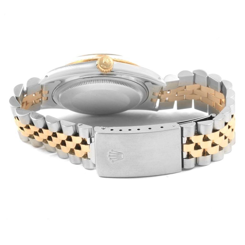 The Rolex Datejust 16013 Men's Stainless Steel Champagne Dial 16013 Men's Stainless Steel Champagne Dial watch is shown from the back, highlighting its case back and two-tone bracelet with a clasp.