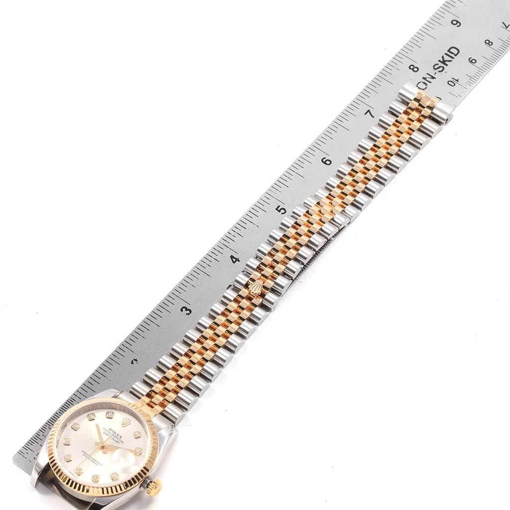 The image shows a Rolex Datejust 116233 Men's Stainless Steel Silver Dial 116233 Men's Stainless Steel Silver Dial watch with its bracelet laid next to a ruler, demonstrating its length.