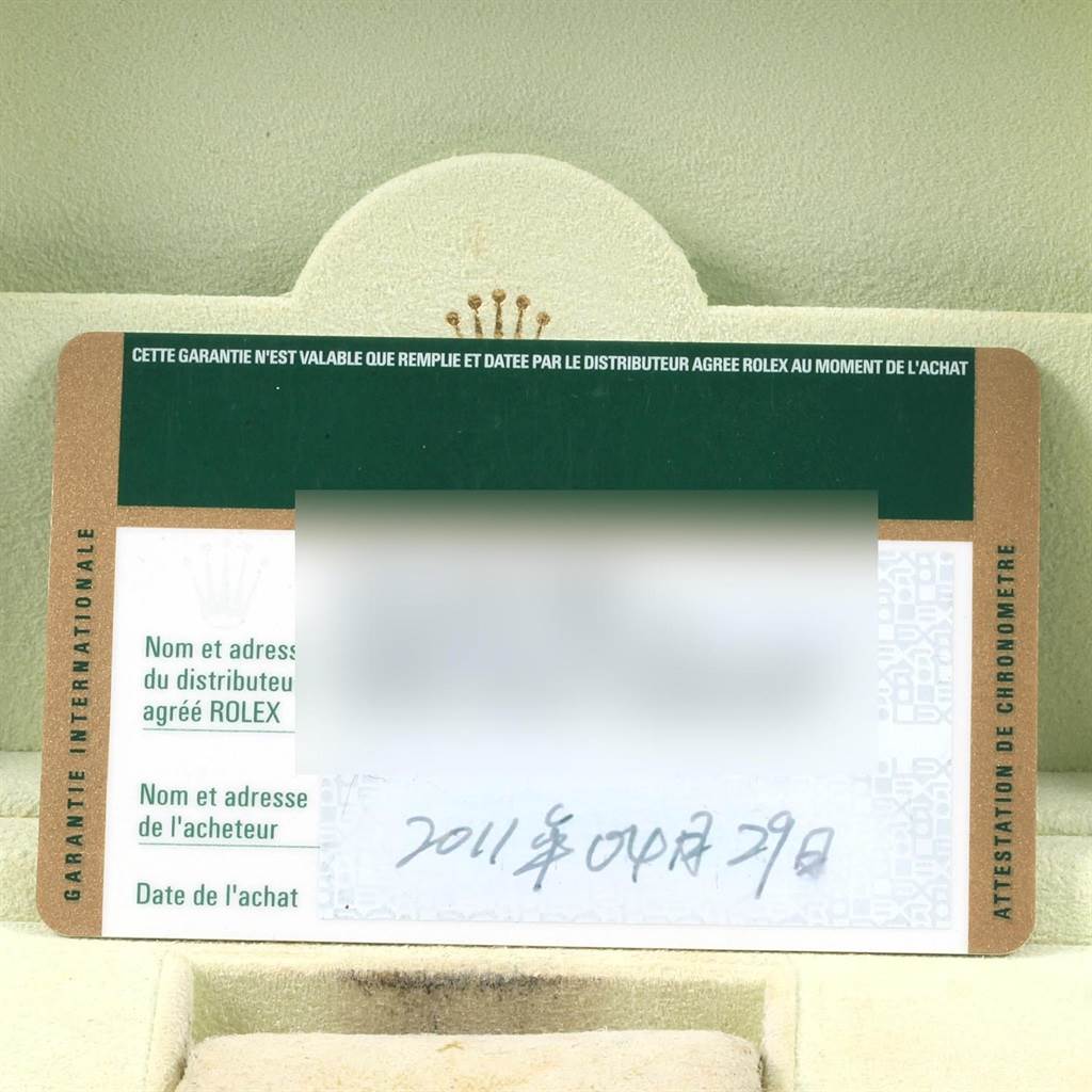 The image shows a partially visible warranty card for the Rolex Datejust 116233 Men's Stainless Steel Silver Dial 116233 Men's Stainless Steel Silver Dial model, placed inside its packaging.