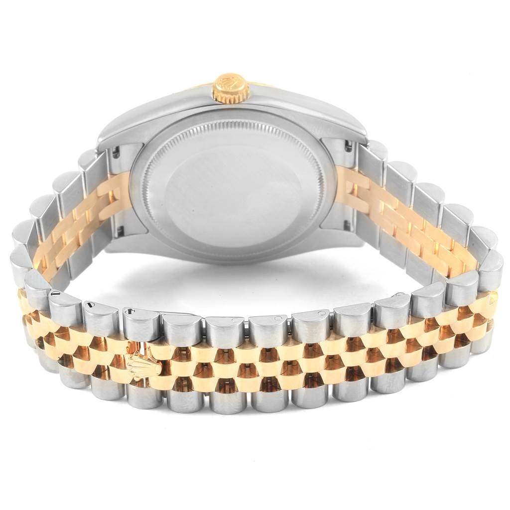 The Datejust Rolex watch is shown from the back with focus on the caseback, crown, and the two-tone Jubilee bracelet.