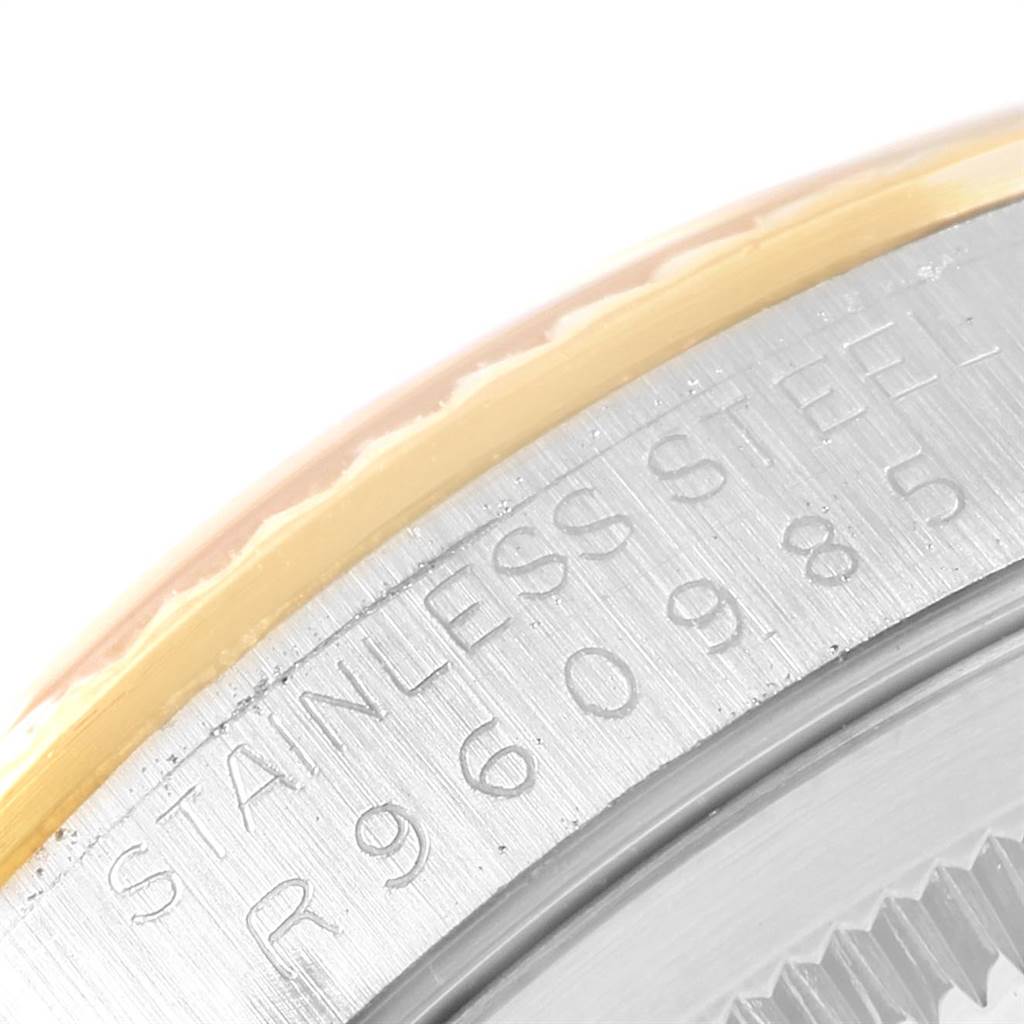 This image shows a close-up of the stainless steel and gold bezel of a Rolex Datejust 16233 Men
s Steel and Gold (two tone) Beige Dial 16233 Men
s Steel and Gold (two tone) Beige Dial watch, including part of the engraved serial number.