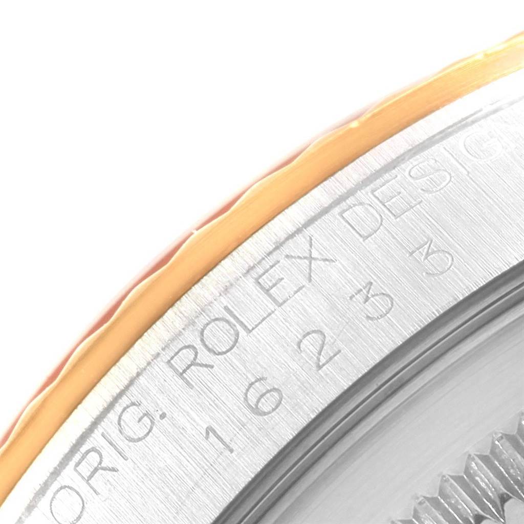 This image shows a close-up of the bezel and side engraving on a Rolex Datejust 16233 Men's Steel and Gold (two tone) Champagne Dial 16233 Men's Steel and Gold (two tone) Champagne Dial watch.