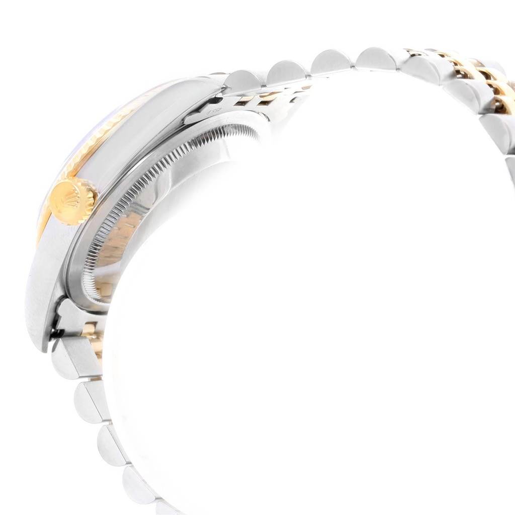 This image of the Rolex Datejust 16233 Men's Steel and Gold (two tone) Black Dial 16233 Men's Steel and Gold (two tone) Black Dial watch displays a side view highlighting the crown and part of the bracelet.