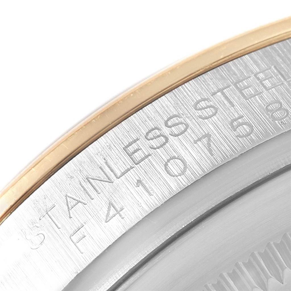 This image shows a close-up of the case back edge of a Rolex Datejust 116203 Men's Stainless Steel Black Dial 116203 Men's Stainless Steel Black Dial watch, highlighting its stainless steel material.