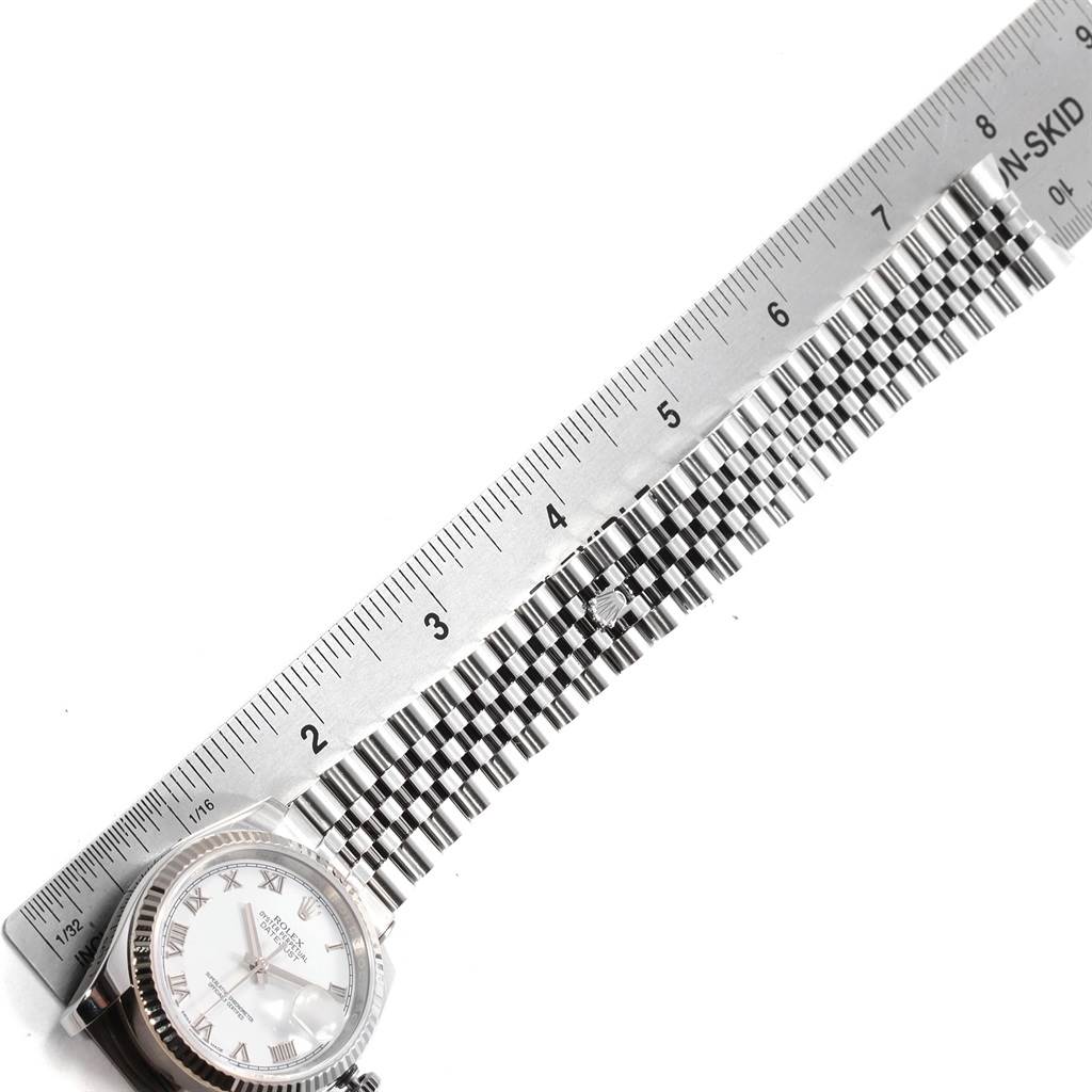 The image shows a Rolex Datejust 392T2233 Men
s Stainless Steel White Dial 392T2233 Men
s Stainless Steel White Dial watch with a portion of its bracelet measured using a ruler.