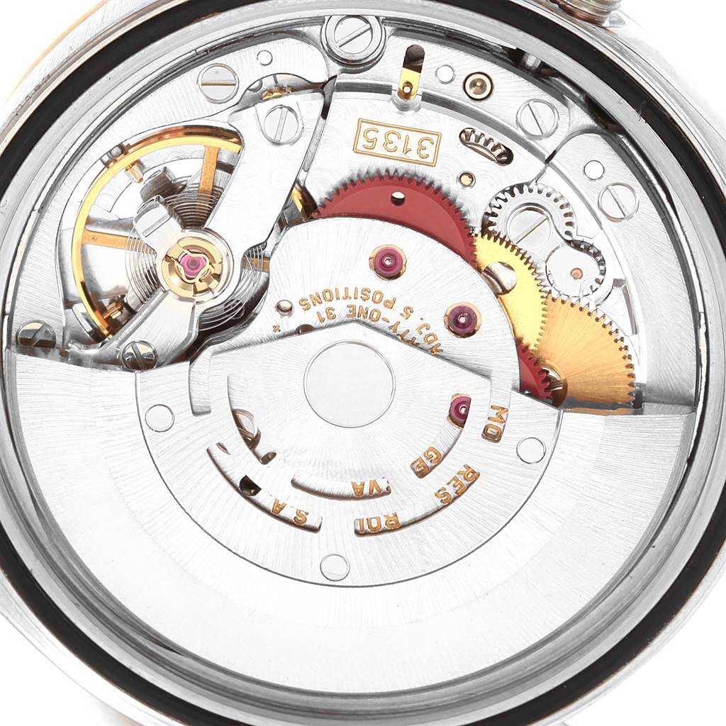 This image shows a close-up view of the internal mechanics of a Rolex Datejust 16233 Men's Steel and Gold (two tone) Black Dial 16233 Men's Steel and Gold (two tone) Black Dial watch, highlighting the movement and gears.