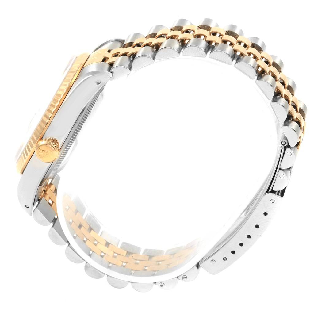 This image shows a side view of a Rolex Datejust 16233 Men's Steel and Gold (two tone) Black Dial 16233 Men's Steel and Gold (two tone) Black Dial model, highlighting its two-tone bracelet, crown, and bezel.