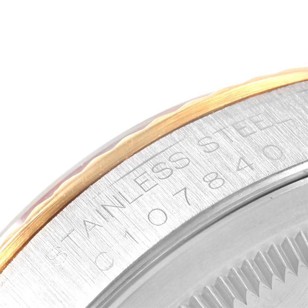 This close-up angle shows the stainless steel and gold edge of a Rolex Datejust 16233 Men's Steel and Gold (two tone) Black Dial 16233 Men's Steel and Gold (two tone) Black Dial model, highlighting the engraved text.