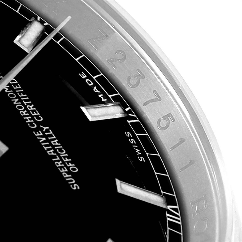 The image shows a close-up of the dial and part of the bezel of a Rolex Datejust 116200 Men's Stainless Steel Black Dial 116200 Men's Stainless Steel Black Dial, focusing on the hour markers and certification text.