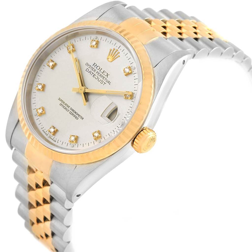 This angled view of the Rolex Datejust 16233 Men's Steel and Gold (two tone) Silver Dial 16233 Men's Steel and Gold (two tone) Silver Dial shows the dial, bezel, crown, and part of the two-tone bracelet.