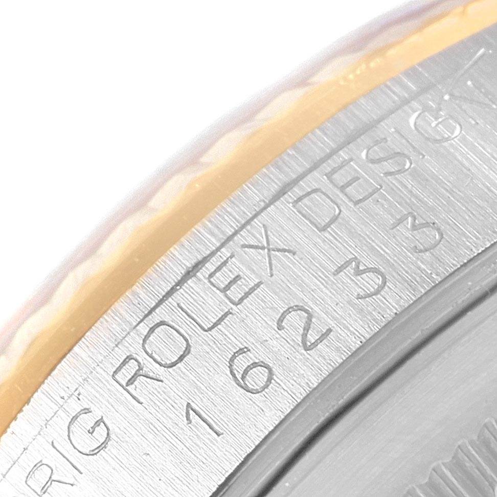 This image shows a close-up angle of the case engraving for a Rolex Datejust 16233 Men's Steel and Gold (two tone) Silver Dial 16233 Men's Steel and Gold (two tone) Silver Dial model watch.