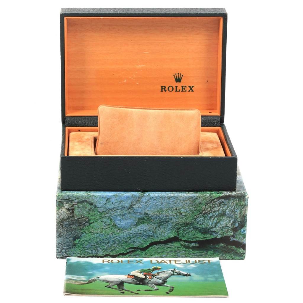 The image shows an open box for a Rolex Datejust 16233 Men's Steel and Gold (two tone) Silver Dial 16233 Men's Steel and Gold (two tone) Silver Dial watch, including an inner cushion and an instruction manual.