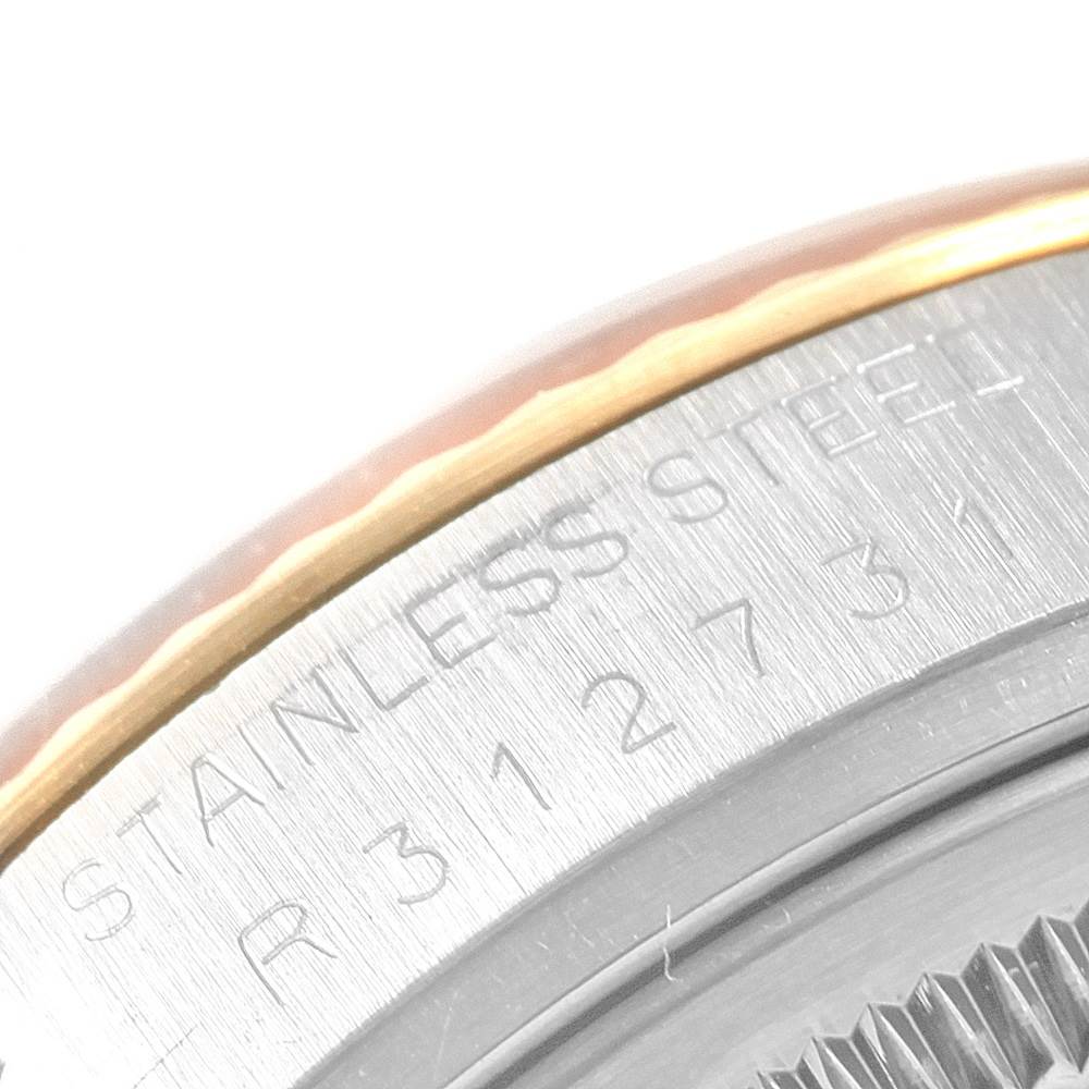 This is a close-up angle of the casing and bezel of a Rolex Datejust 16013 Men
s Stainless Steel Champagne Dial 16013 Men
s Stainless Steel Champagne Dial model, highlighting the "Stainless Steel" engraving.