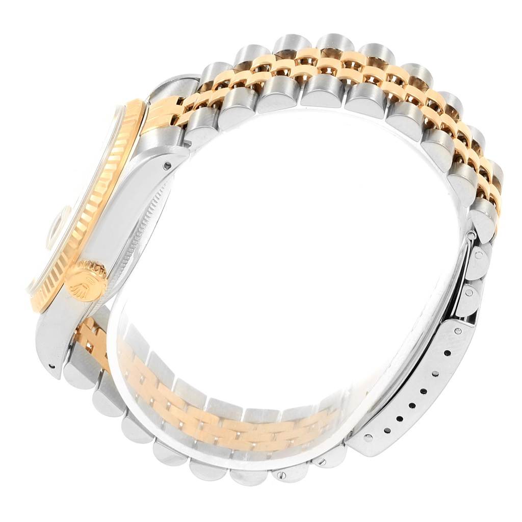 This side-angle view of the Rolex Datejust 16233 Men's Steel and Gold (two tone) White Dial 16233 Men's Steel and Gold (two tone) White Dial watch shows the gold bezel, crown, and two-tone bracelet links.