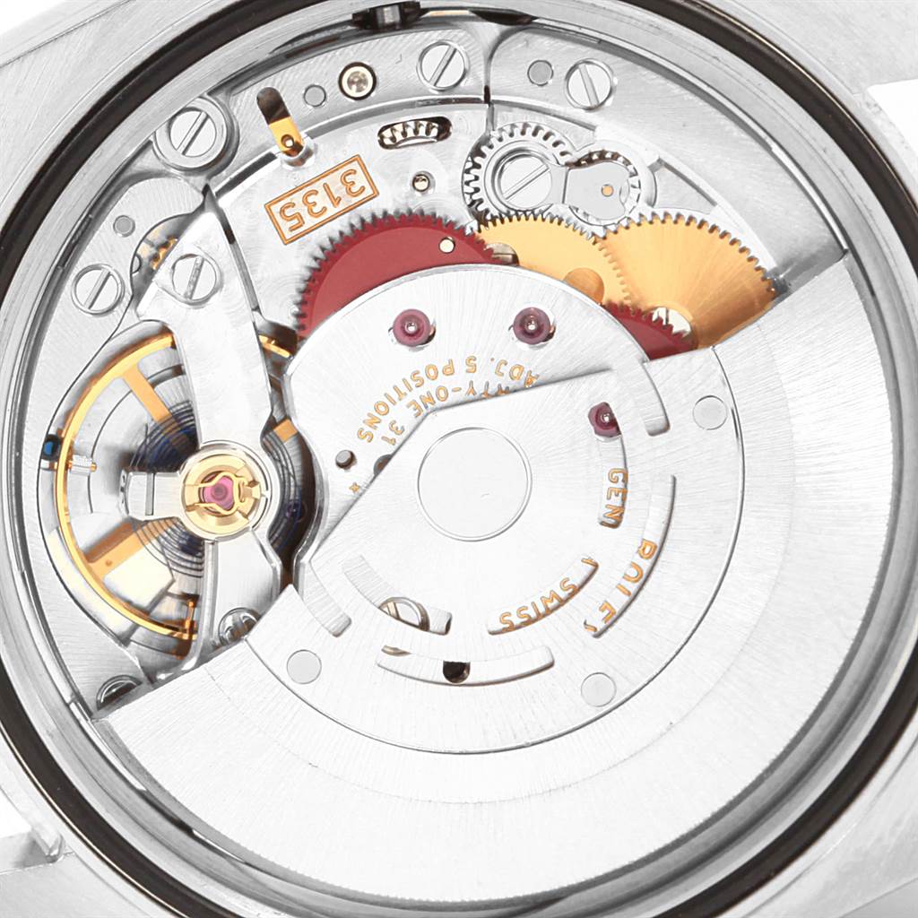 The image shows the inner mechanical movement of the Rolex Datejust 116233 Men's Stainless Steel Black Dial 116233 Men's Stainless Steel Black Dial watch, highlighting gears and various components.