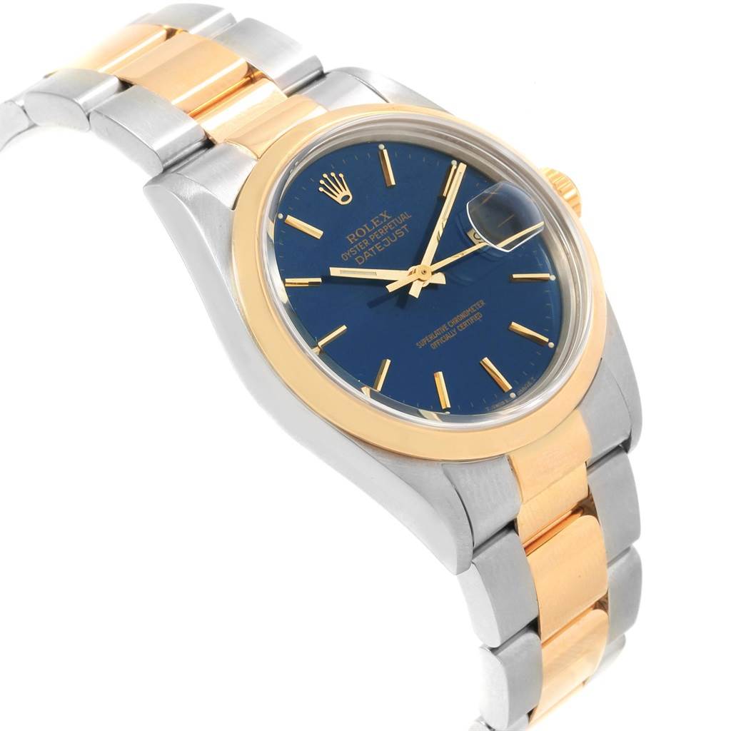 This angled shot of the Rolex Datejust 16203 Men's Steel and Gold (two tone) Blue Dial 16203 Men's Steel and Gold (two tone) Blue Dial watch shows the blue dial, gold hour markers, and two-tone metal bracelet.