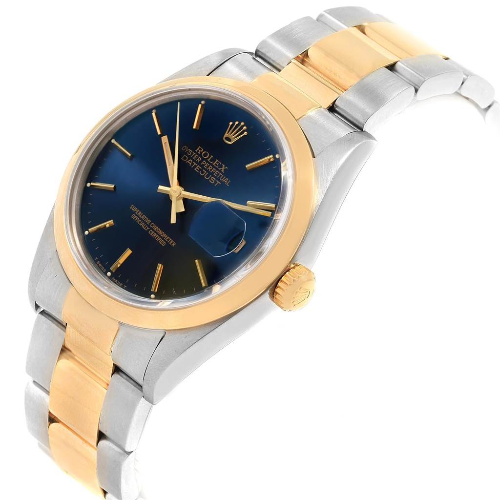 The Rolex Datejust 16203 Men's Steel and Gold (two tone) Blue Dial 16203 Men's Steel and Gold (two tone) Blue Dial watch is shown at an angle displaying its blue dial, gold bezel, crown, and two-tone bracelet.