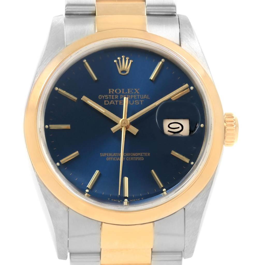 The Rolex Datejust 16203 Men's Steel and Gold (two tone) Blue Dial 16203 Men's Steel and Gold (two tone) Blue Dial watch features a gold and silver case, blue dial, gold markers, and date magnifier, shown from a front view angle.