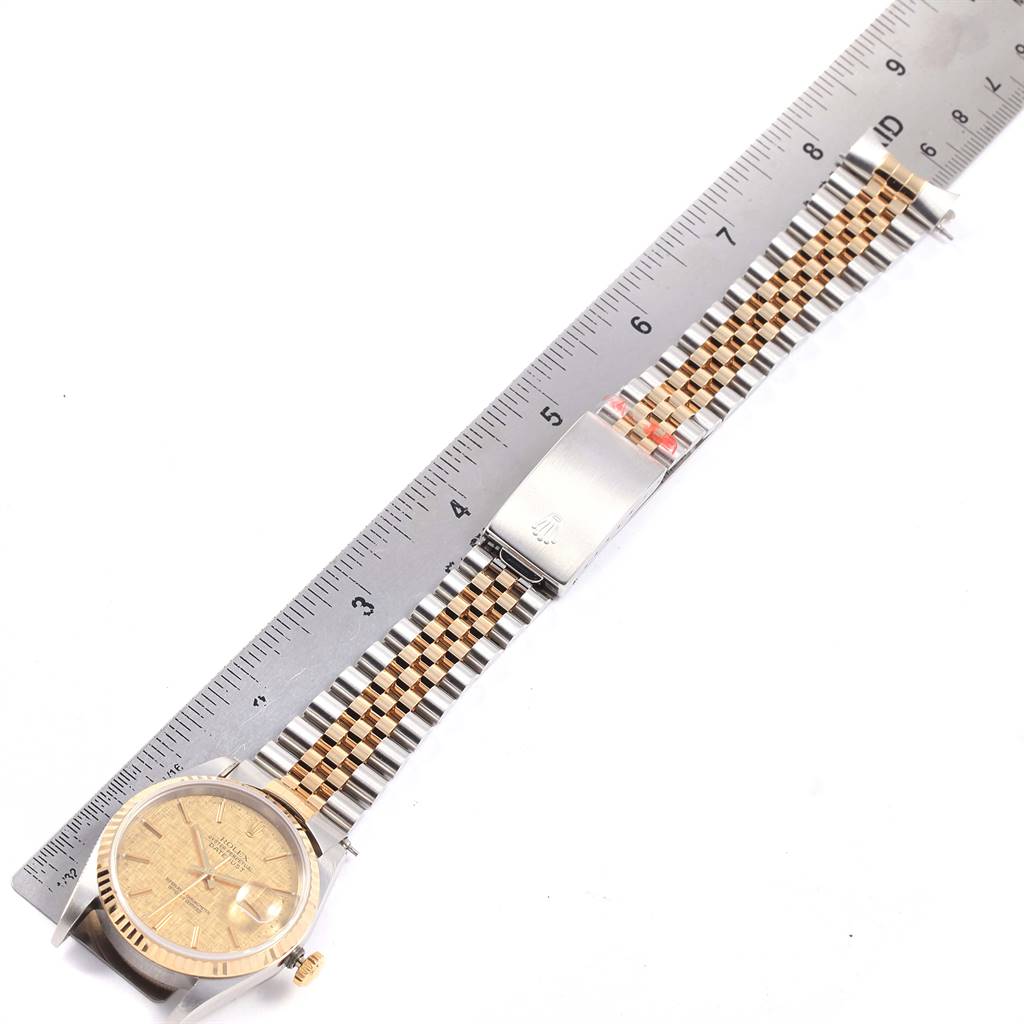 The image shows a Rolex Datejust 16233 Men's Steel and Gold (two tone) Champagne Dial 16233 Men's Steel and Gold (two tone) Champagne Dial watch with a two-tone wristband laid flat alongside a ruler for measurement.
