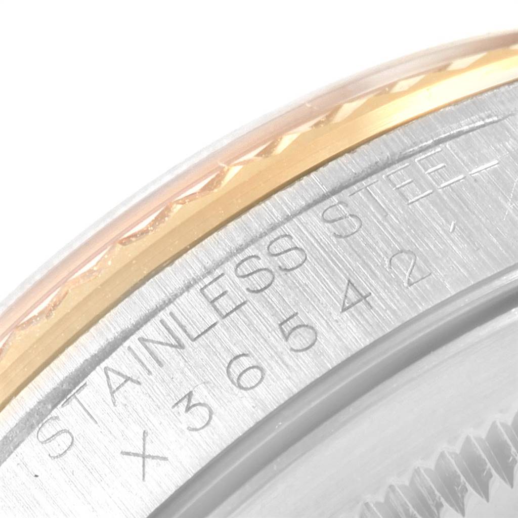 This image shows a close-up of the bezel and engraved stainless steel caseback of a Rolex Datejust 16233 Men's Steel and Gold (two tone) Champagne Dial 16233 Men's Steel and Gold (two tone) Champagne Dial watch.