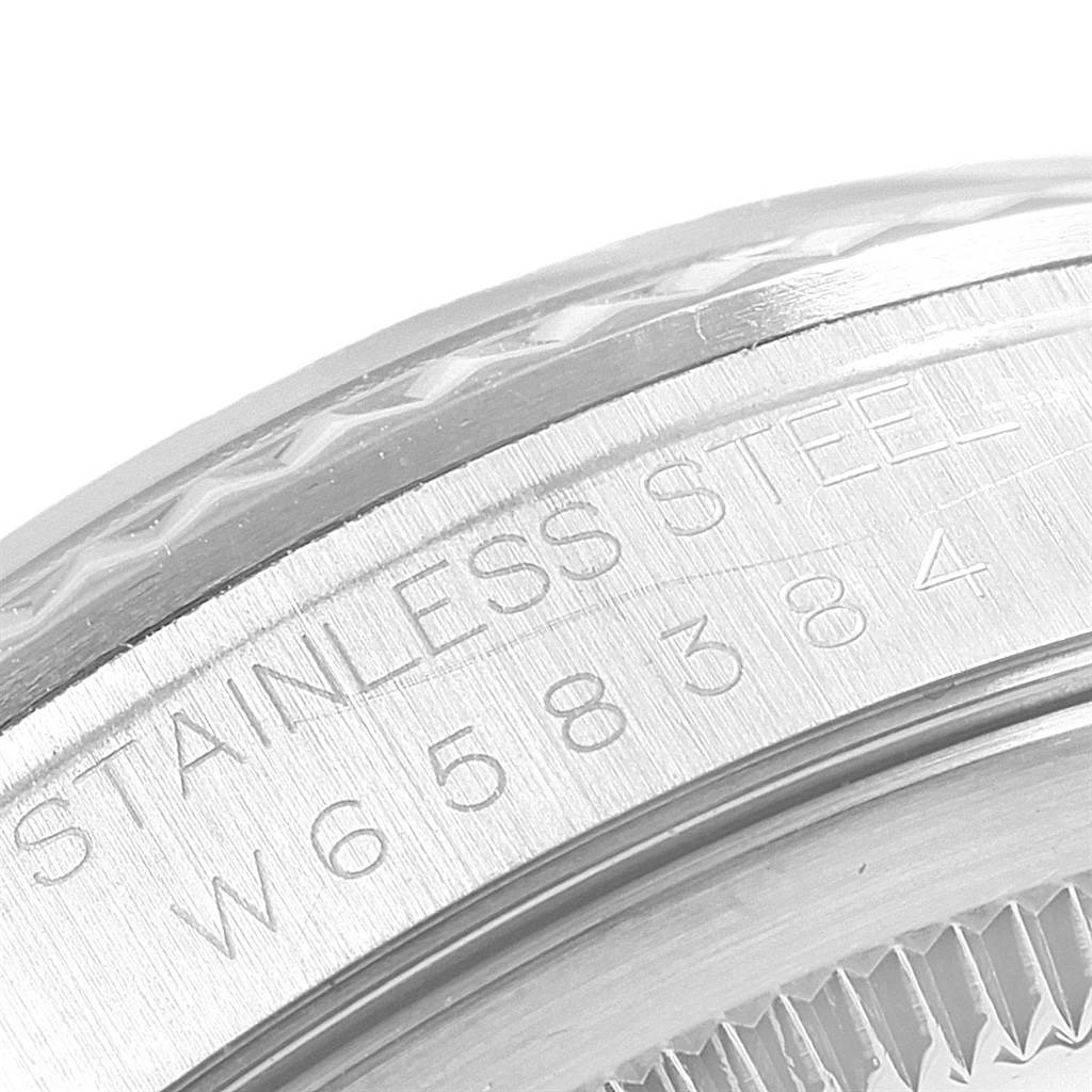 This close-up image shows part of the stainless steel casing with engraved serial numbers of the Rolex Datejust 20800 Men
s Stainless Steel Silver Dial 20800 Men
s Stainless Steel Silver Dial watch.
