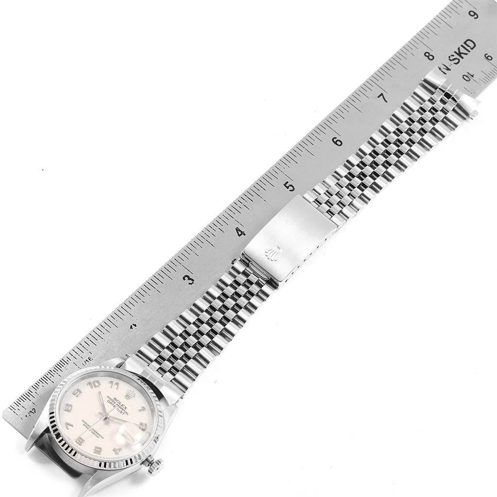 The image shows a Rolex Datejust 20800 Men
s Stainless Steel Silver Dial 20800 Men
s Stainless Steel Silver Dial watch laid flat with the dial, bracelet, and clasp visible next to a ruler.