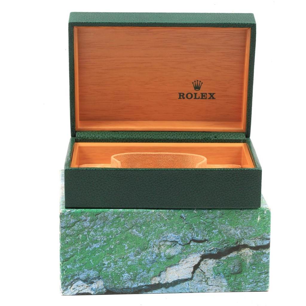 The image shows an open green leather Rolex Datejust 20800 Men
s Stainless Steel Silver Dial 20800 Men
s Stainless Steel Silver Dial watch box with a wooden interior and cushion.