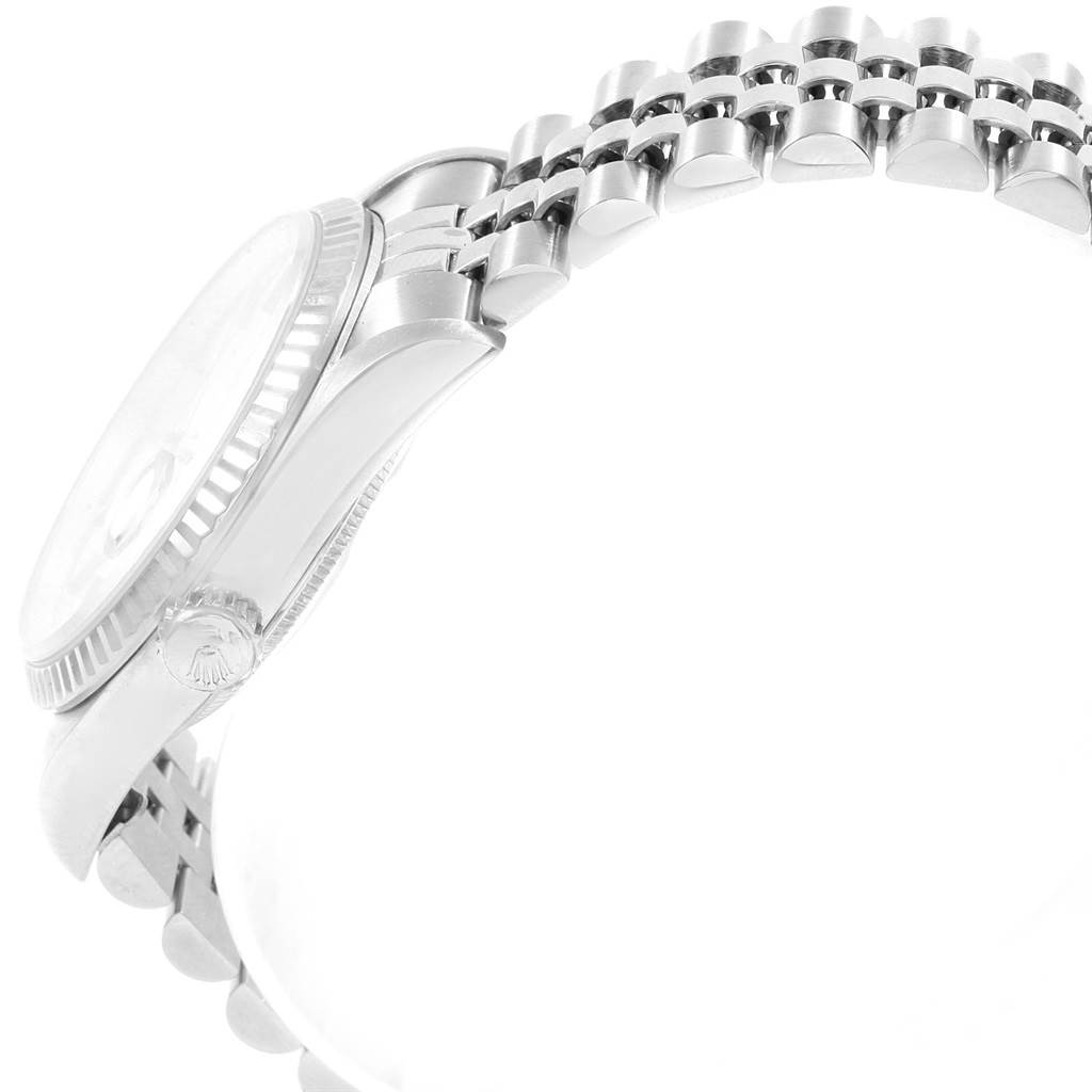 This side view of the Rolex Datejust 20800 Men
s Stainless Steel Silver Dial 20800 Men
s Stainless Steel Silver Dial watch shows the case, crown, and part of the bracelet.