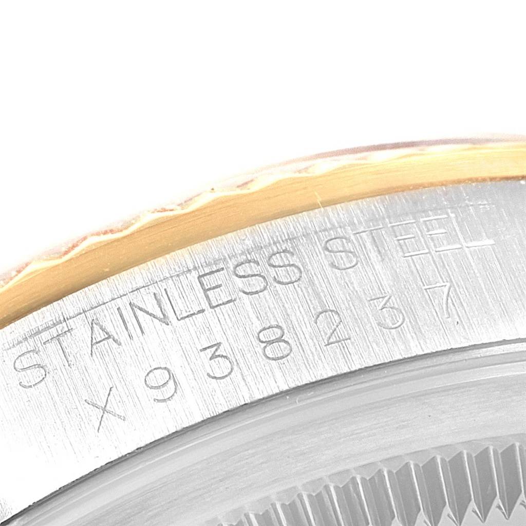 This image shows a close-up of the stainless steel case back with serial numbers of a Rolex Datejust 16233 Men
s Steel and Gold (two tone) Champagne Dial 16233 Men
s Steel and Gold (two tone) Champagne Dial watch.